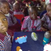 Distributing toys to children at a nursery school